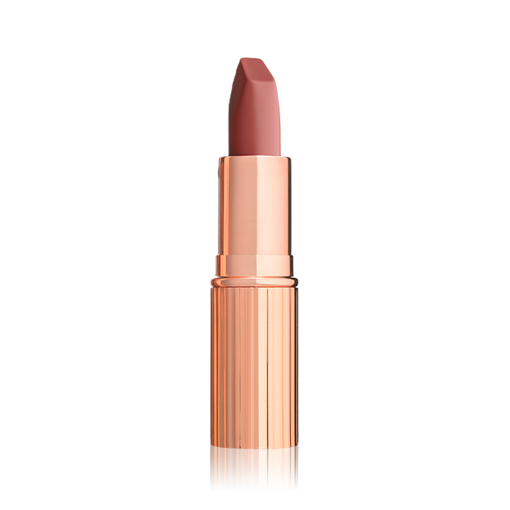 An open matte lipstick in a warm coral rose with a gold-coloured tube.