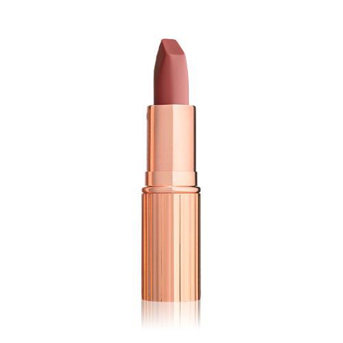 An open matte lipstick in a warm coral rose with a gold-coloured tube.