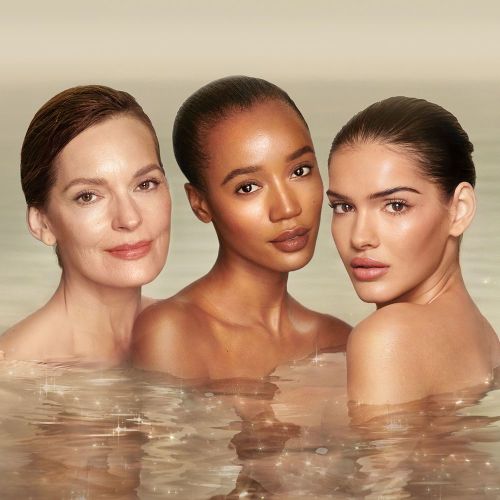 Three, fair, tan and deep skin models with glowing skin in a sparkling ocean and shoulder bare. 