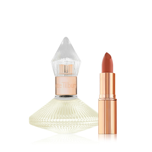 A 50 ml perfume in a glass bottle with a glass lid with an open lipstick in a peachy-red shade in a golden-coloured tube. 