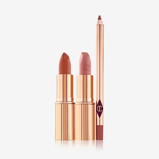 Rose Pink Lip Kit open Two open lipsticks, one in a brick red shade with a satin finish and the other in a soft peachy-rose shade with a matte finish in sleek, gold-coloured tubes with a lip liner pencil in a dark brown-red shade.