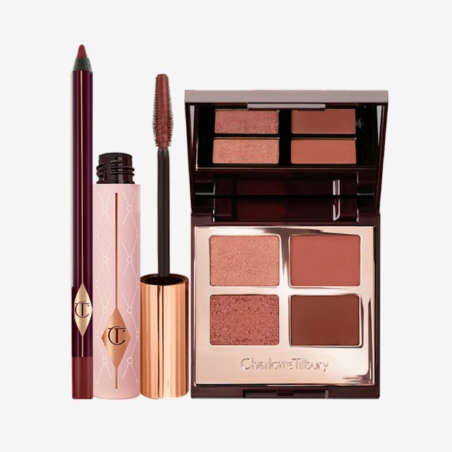 Pillow Talk Eye Enhancing Secrets bundle open A berry-brown eyeliner, dark brown mascara, and quad eyeshadow palette with a mirrored-lid in shimmery and matte shades of brown and gold.