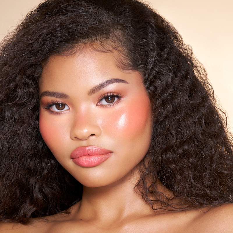 Model wearing Sun-Blushed Glow lip and cheek tint as a lip tint