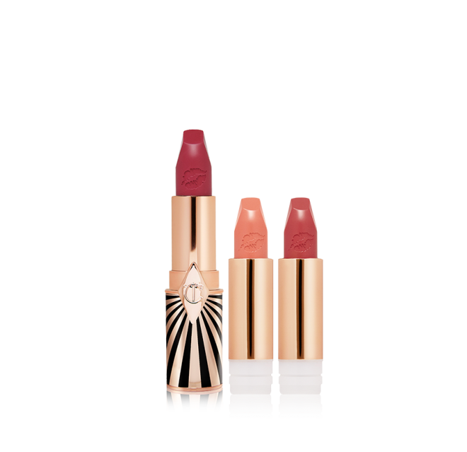 three, open, refillable lipsticks in berry-rose, nude peachy-pink, and warm orange-red in golden and black-coloured packaging.