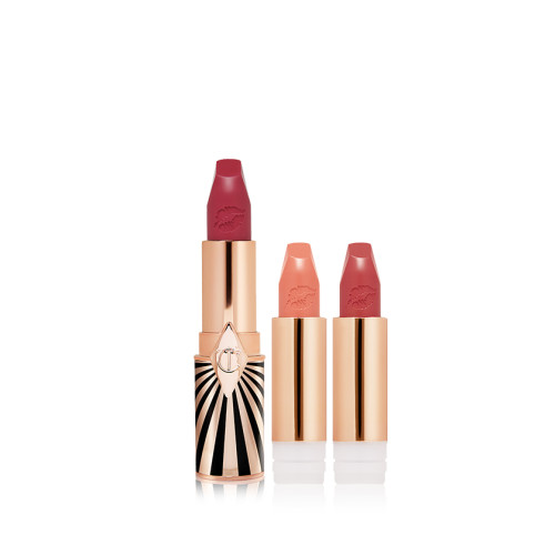 three, open, refillable lipsticks in berry-rose, nude peachy-pink, and warm orange-red in golden and black-coloured packaging.