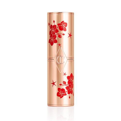 A lipstick tube with gold and red blossom packaging 