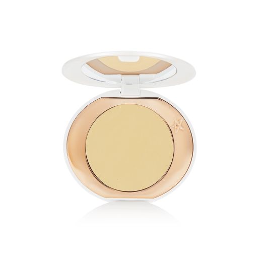 A miniature compact brightening powder in a white shade for tan and deep skin tones.
