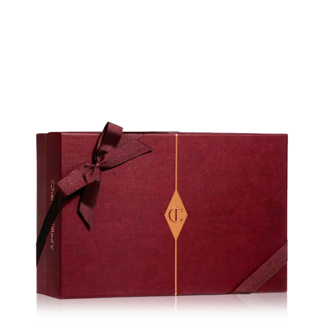 A maroon-coloured gift box with a maroon-coloured bow and the CT logo in golden-colour printed on the box. 