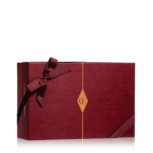 A maroon-coloured gift box with a maroon-coloured bow and the CT logo in golden-colour printed on the box. 