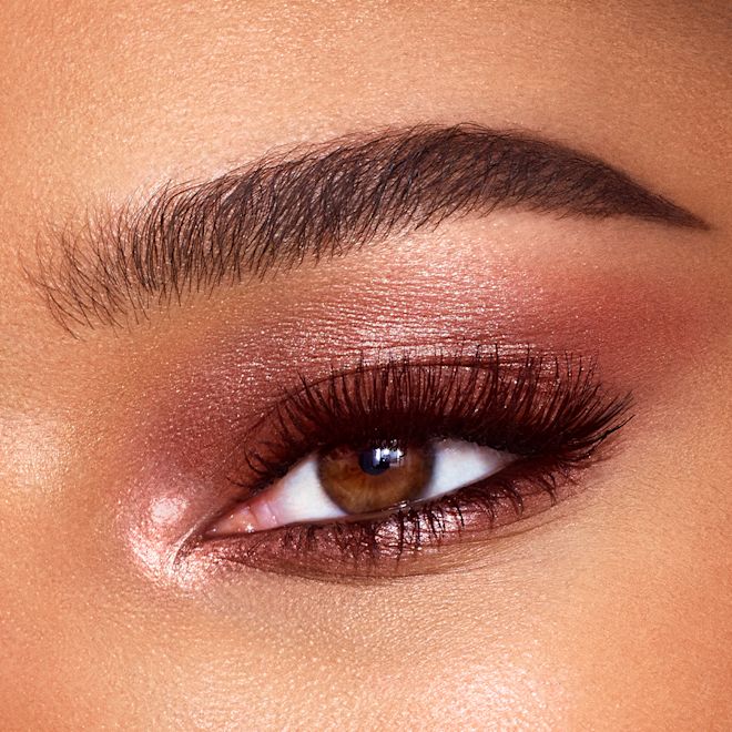 Eyes to Mesmerise in Sunset Rose on brown eye close-up Close-up of a single brown eye with shimmery, rose-gold-coloured cream eyeshadow.