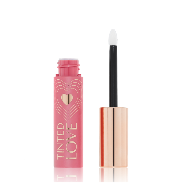 An open lip and cheek tint in a rosy pink shade with a pink-coloured bottle with a white and gold-coloured doe-foot applicator. 