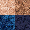 Swatches of four, matte and shimmery eyeshadows in shades of blue and gold. 