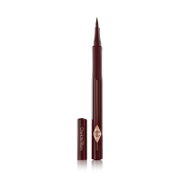 An open, chocolate brown eyeliner pen with a felt tip, a CT symbol embossed on it, and its cap next to it. 