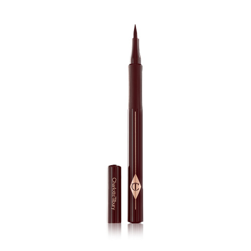 An open, chocolate brown eyeliner pen with a felt tip, a CT symbol embossed on it, and its cap next to it. 