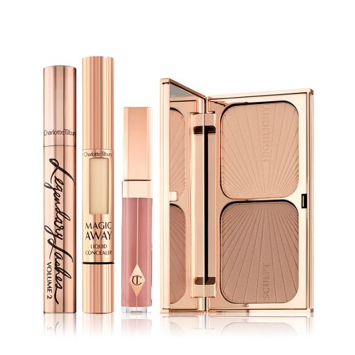 A mascara in a gold-coloured tube with a concealer with a small window on the tube that shows the colour of the concealer inside, nude pink lip gloss, and a duo contour palette with a mirrored-lid. 