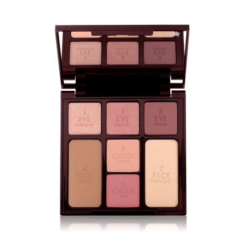 An open, face palette with a mirrored-lid with three rose gold, dusky pink, and plum-coloured eyeshadows, two blushes in soft peach and medium-pink, light brown bronzer, and soft, gold-coloured highlighter.