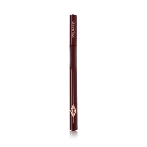 A dark brown eyeliner pen with its lid closed and the CT symbol embossed on it. 