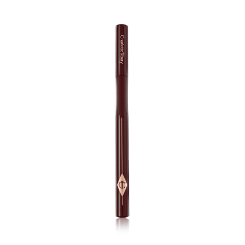 A dark brown eyeliner pen with its lid closed and the CT symbol embossed on it. 