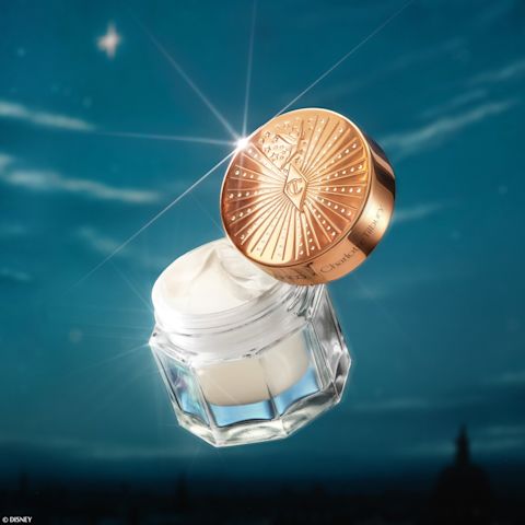 Disney 100  x Charlotte Tilbury limited-edition Charlotte's Magic Cream with Tinkerbell design on night sky backdrop
