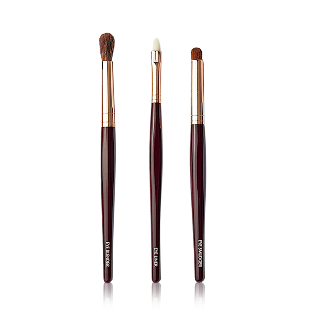Three synthetic makeup brushes with black-brown handles and soft bristles.