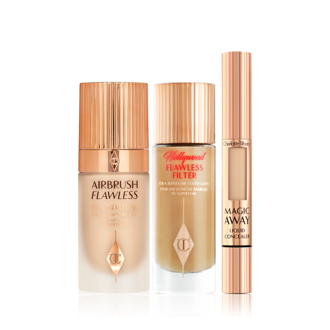 A glowy primer in a glass bottle with gold-coloured lid, foundation in a frosted glass bottle with gold-coloured lid, and creamy concealer in a gold-coloured tube. 