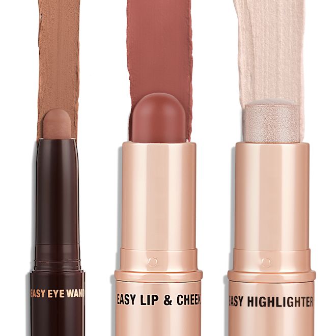 Quick & Easy Instant 5 Minute Super Chic Look Kit products displayed An open shadow stick in a matte nude brown shade, a lip and cheek blush stick in a soft pink shade, and highlighter stick in an opal shade.