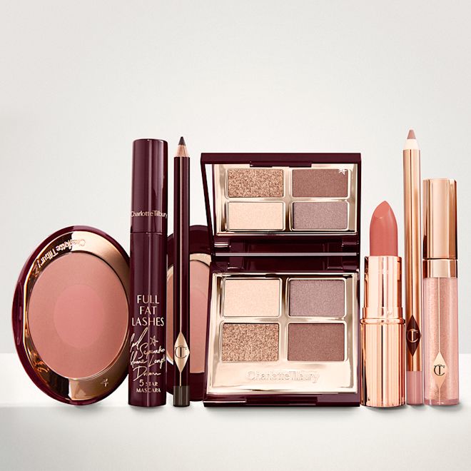 The Golden Goddess kit for Fair, Light and Medium tones displayed An open, mirrored-lid eyeshadow palette in matte and shimmery gold, brown, and beige shades, an open black eyeliner pencil, a mascara in a dark-crimson colour scheme, a golden-peach lipstick with a matching lip liner pencil, nude-peach lip gloss, and an open two-tone blush in muted brown-pink.