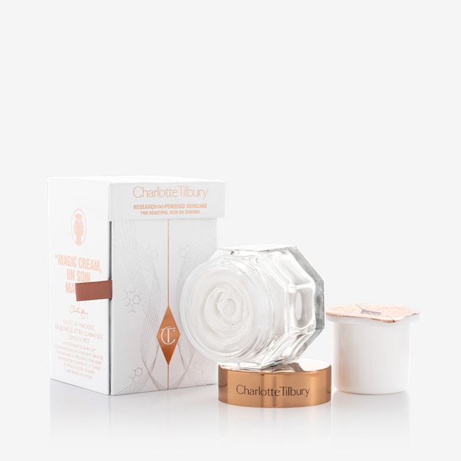 Magic Cream with refill bundle Pearly-white cream in a glass jar with a gold-coloured lid along with its packaging box refill in a white-coloured pot with an easy-to-peel-off cover.