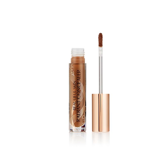 Radiant concealer in a glass tube with its doe-foot applicator next to it with a gold-coloured handle.