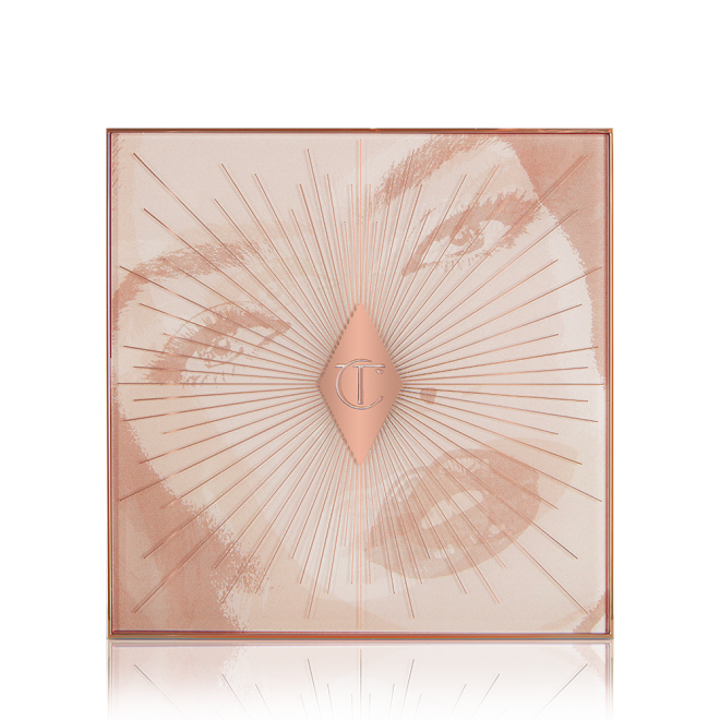 A closed face palette with a starburst pattern on top and an illustration of a face with smokey eye makeup and plump lips with lip gloss on.