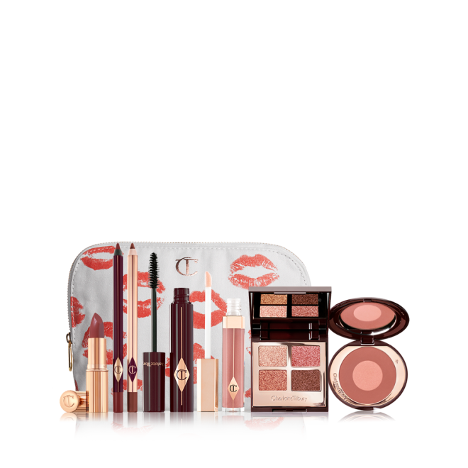 A white makeup pouch with open products displayed, which include a berry-rose lipstick, maroon eyeliner pen, berry-rose lip liner pencil, mascara, nude-pink lip gloss, a mirrored-lid quad eyeshadow palette, and a two-tone warm-pink blush. 