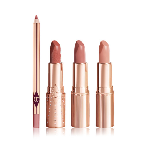 An open lip liner pencil in a nude pink shade with three open lipsticks in gold-coloured tubes with nude peach, nude brown peach, and nude peach beige colours. 