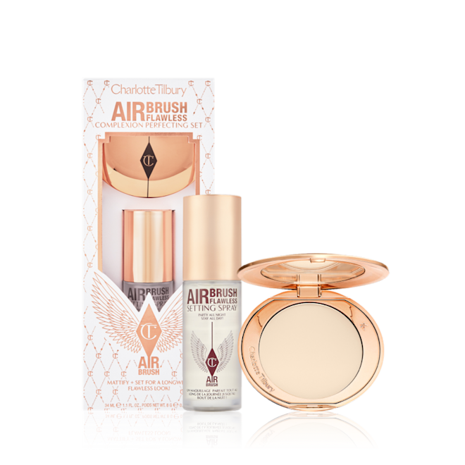 Airbrush Flawless Complexion Perfecting Set with box displayed Setting spray in a clear bottle with a gold-coloured lid with a setting powder compact in gold-packaging with a mirrored-lid along with a white and pink-coloured packaging box.