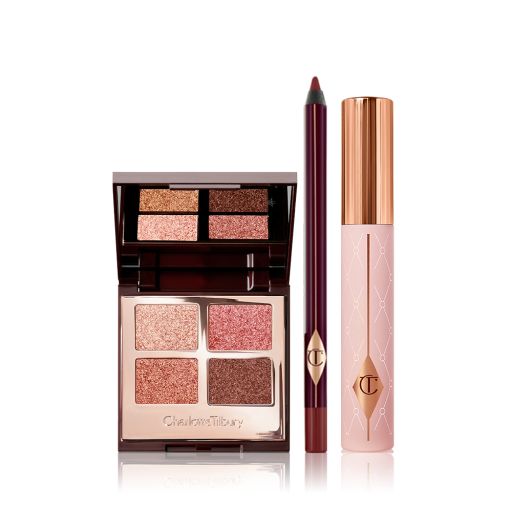 Quad, mirrored-lid eyeshadow palette with shimmery brown, gold, and pink eyeshadows with a berry-brown eyeliner pencil, and black mascara with nude pink bottle and gold-coloured lid.