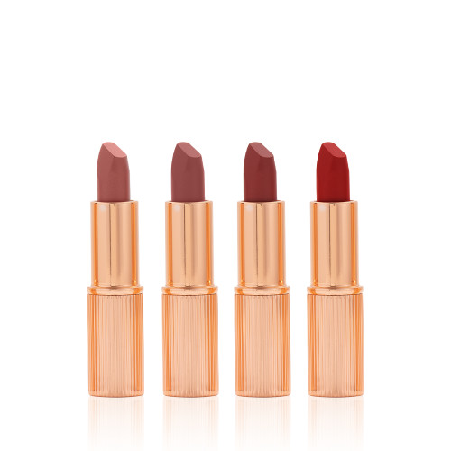 Five matte lipsticks in nude shades of red and pink in sleek, gold-coloured tubes with their lids removed.