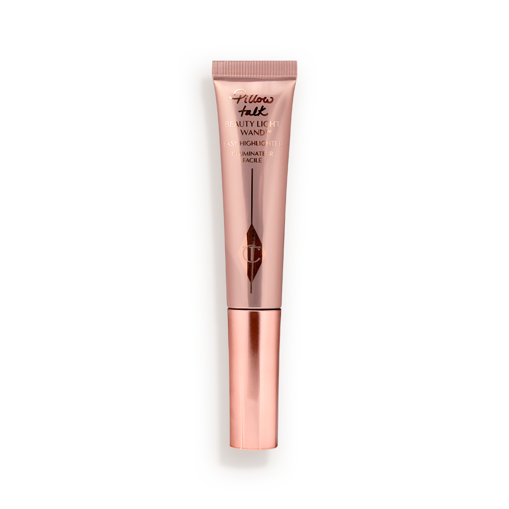 Liquid highlighter wand in a reflective, pale pink tube with a rose gold cap.