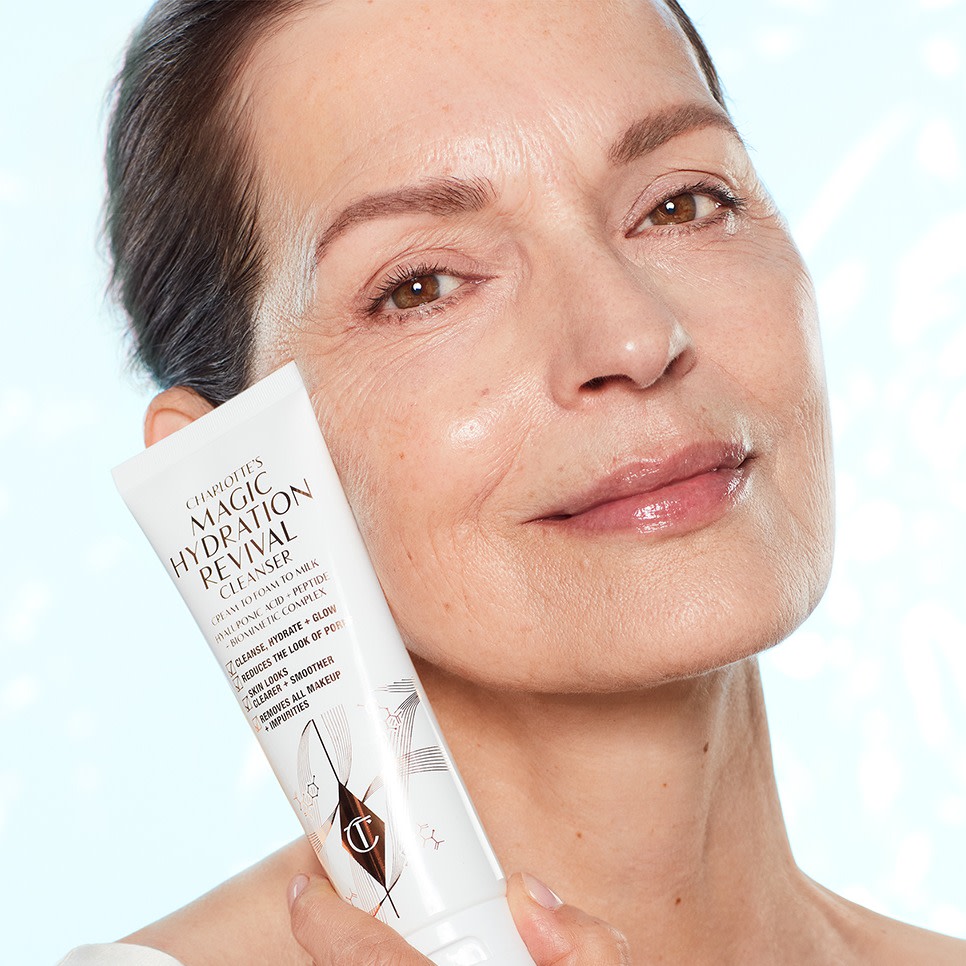 Robina holding Charlotte's Magic Hydration Revival Cleanser skincare for mature skin