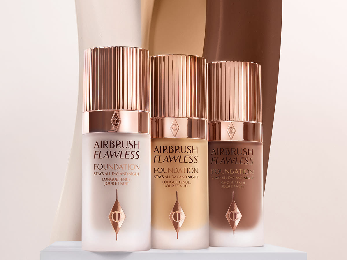 Three foundations in fair, medium, and dark shades with frosted glass bottles and rose-gold-coloured lids. 