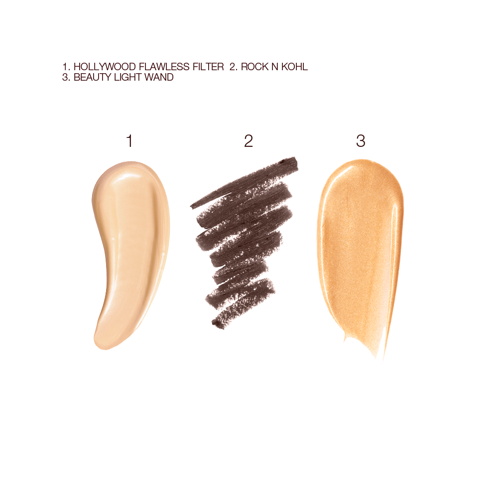 Swatches of a luminous, champagne-coloured creamy primer, a kohl liner in dark brown, and a highlighter in a warm golden shade. 