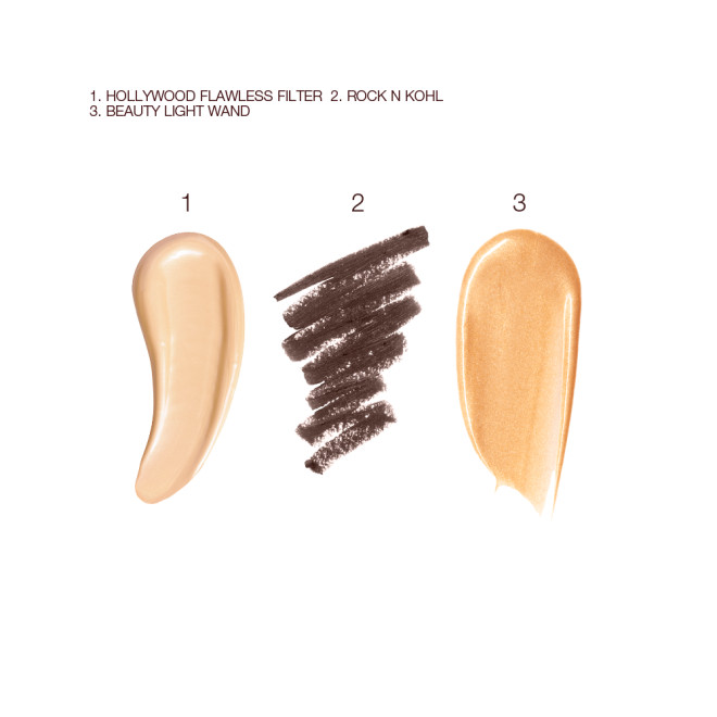 Swatches of a luminous, champagne-coloured creamy primer, a kohl liner in dark brown, and a highlighter in a warm golden shade. 