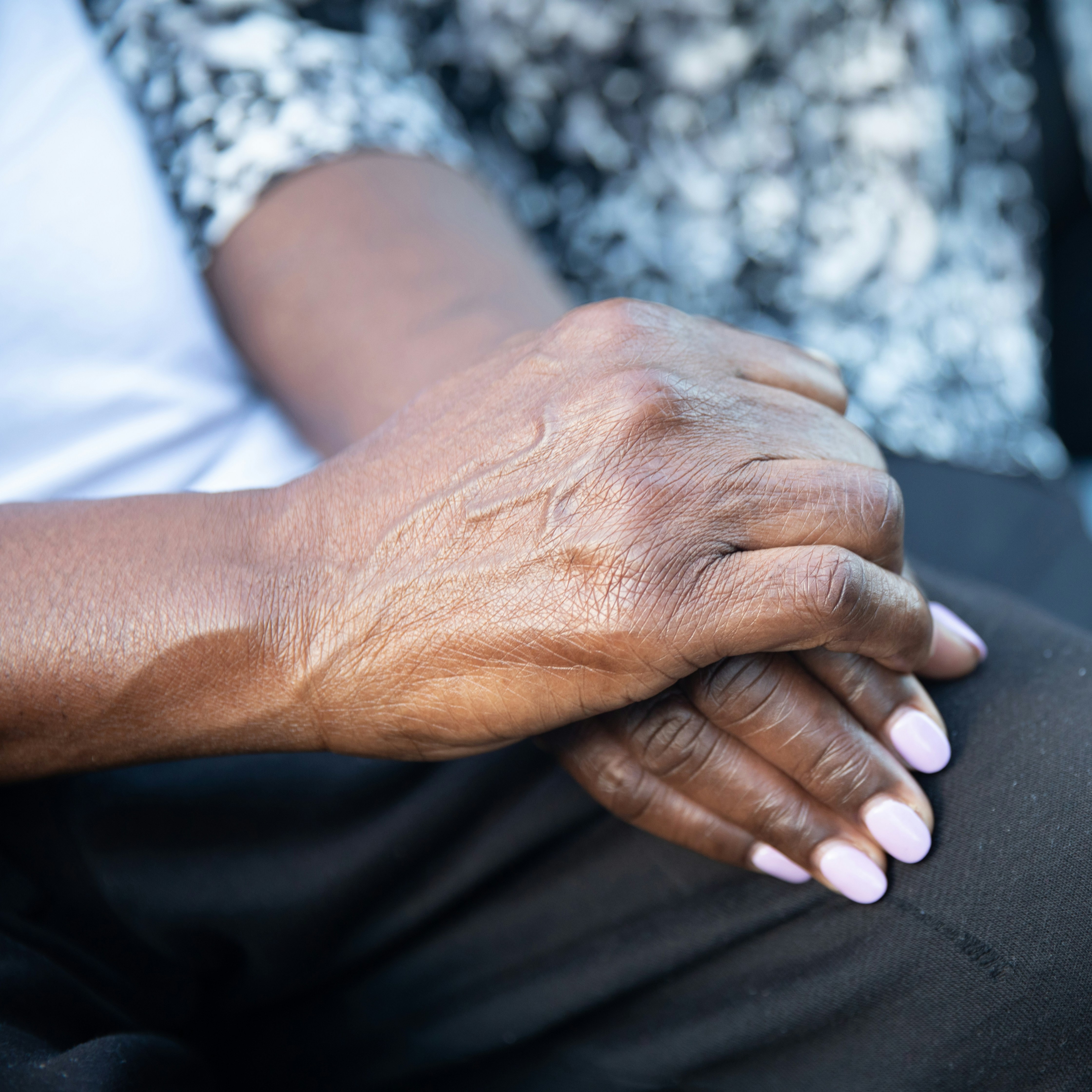 Older and younger person linking hands Healthy Ageing Month