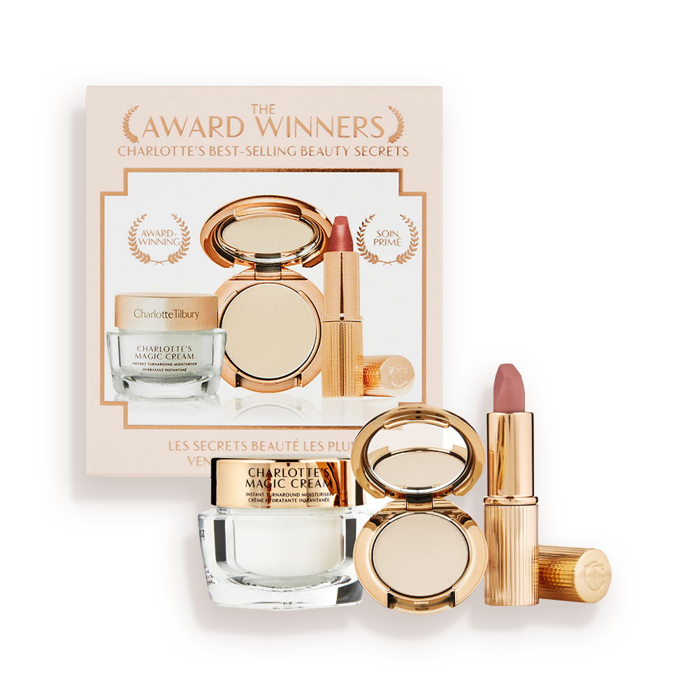 Pearly-white face cream in a glass jar with a gold-coloured lid, pressed powder compact in a fair shade, and a dusky pink lipstick in a sleek gold-coloured tube.
