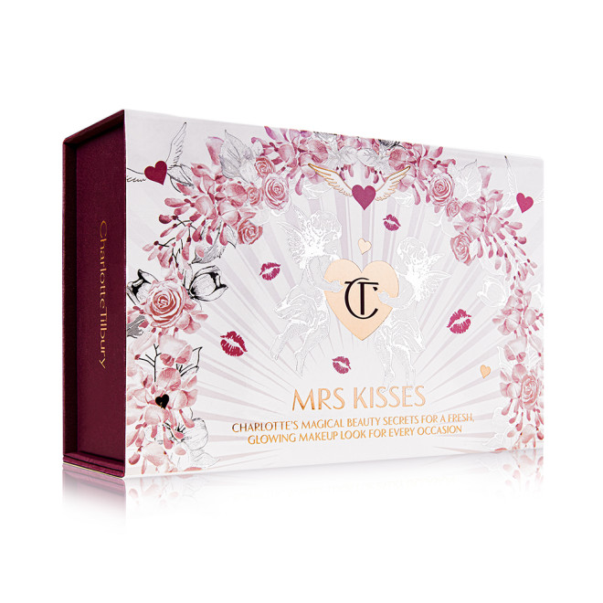 A makeup kit in a white-coloured gift box with hearts and lipstick kiss prints all over with the text, 'Mrs kisses' written on the front. 