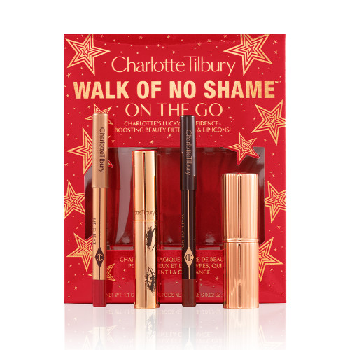 Eyeliner pencil in a berry-pink shade, mascara in a golden-coloured tube, lip liner pencil in berry-red shade, lipstick in a sleek, gold-coloured tube with red-coloured gift box with text on it reads, 'Walk of no shame on the go'.