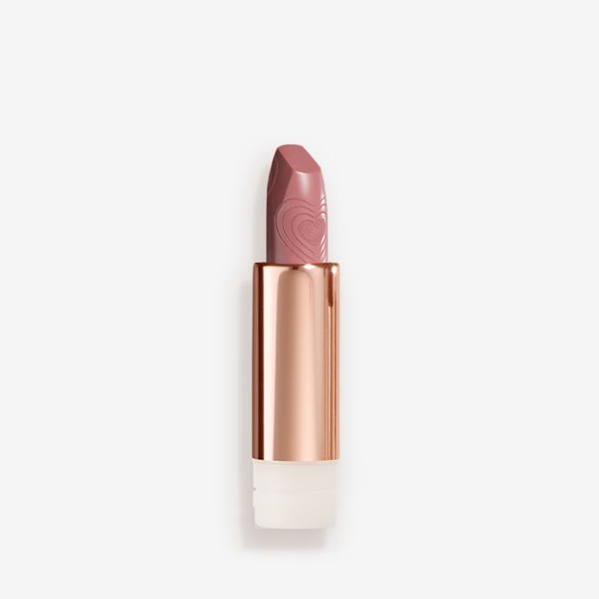 Look of Love Matte Revolution Lipstick Refill in Wedding Belles open An open, rose-bud pink lipstick refill in a metallic, golden-coloured tube with its lid next to it.