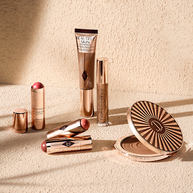 Charlotte's Beautiful Skin collection and Beach Sticks cream blush sticks on a beachy backdrop