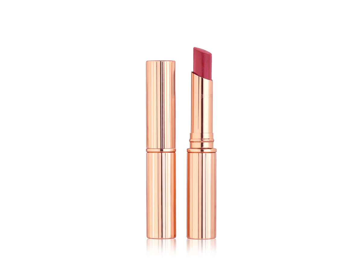 Two lipstick lip balms, with and without lid in a strawberry red shade. 