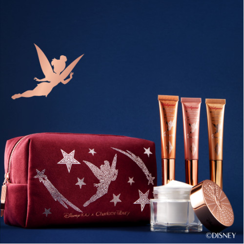 Disney makeup collection in collaboration with Disney100 and Charlotte Tilbury Beauty including moisturiser, liquid highlighter wands and makeup bag with Tinker Bell design.