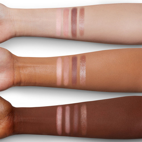 Arm swatches of a quad eyeshadow palette with light pink, dark pink, dark brown, and light brown eyeshadow. 