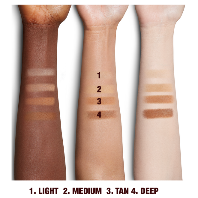 Deep, tan, and fair-tone arms with swatches of pressed powder in light, medium, tan, and deep. 